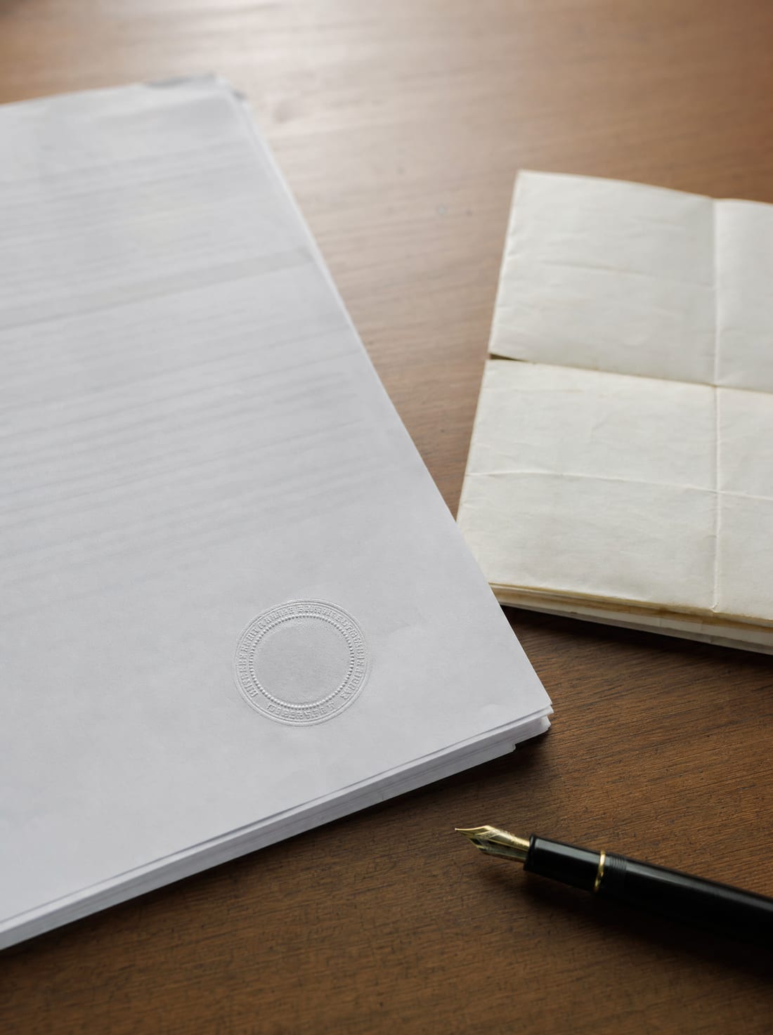 A court judgment document with an embossed seal and a property deed on a desk, for post-judgment actions