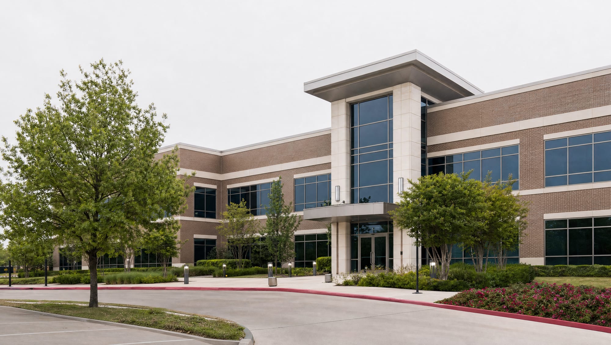 A clean, modern low-rise Texas professional office building with a glass and brick facade, tidy landscaping, and a well-kept entrance, representing a growing business