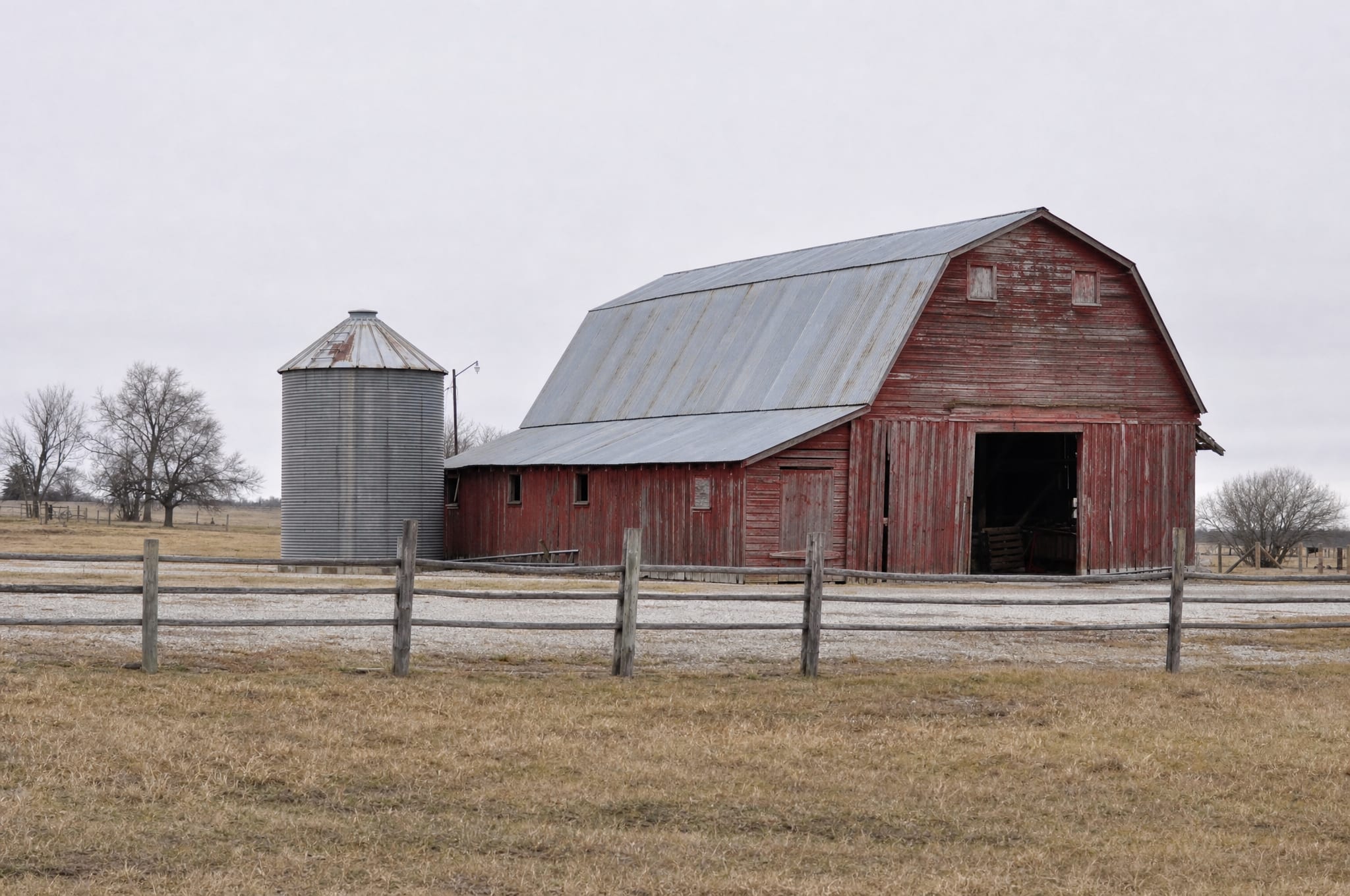 A Texas farmstead with a red barn and grain silo, a landowner's property