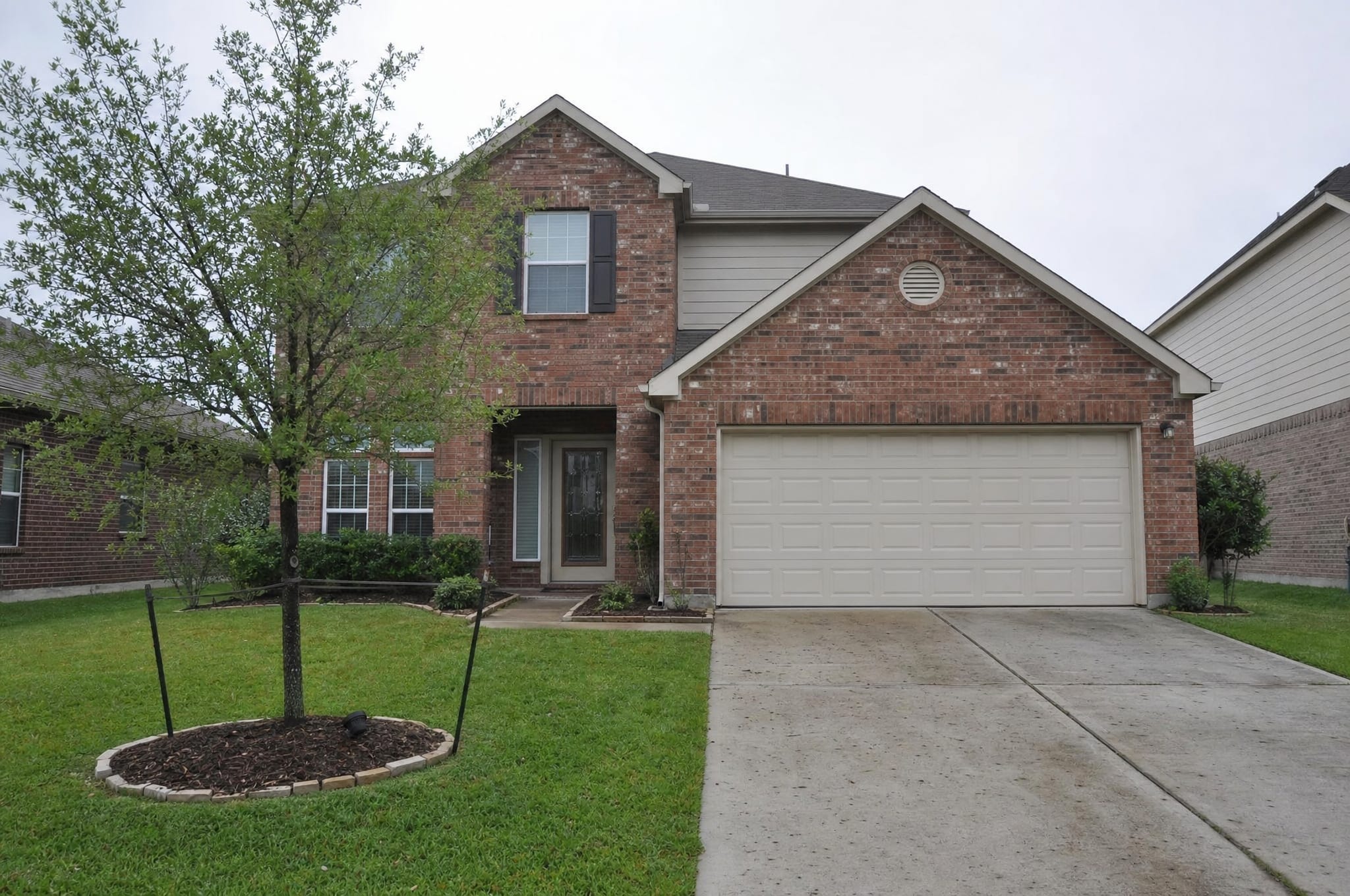 A two-story Texas brick suburban home, a homeowner's property
