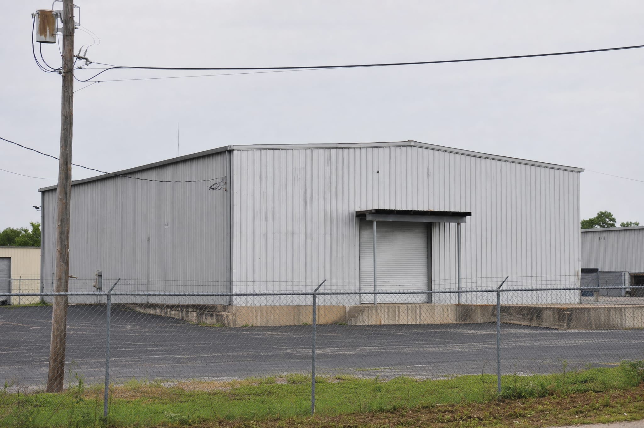A metal warehouse with a loading dock, a light-industrial property