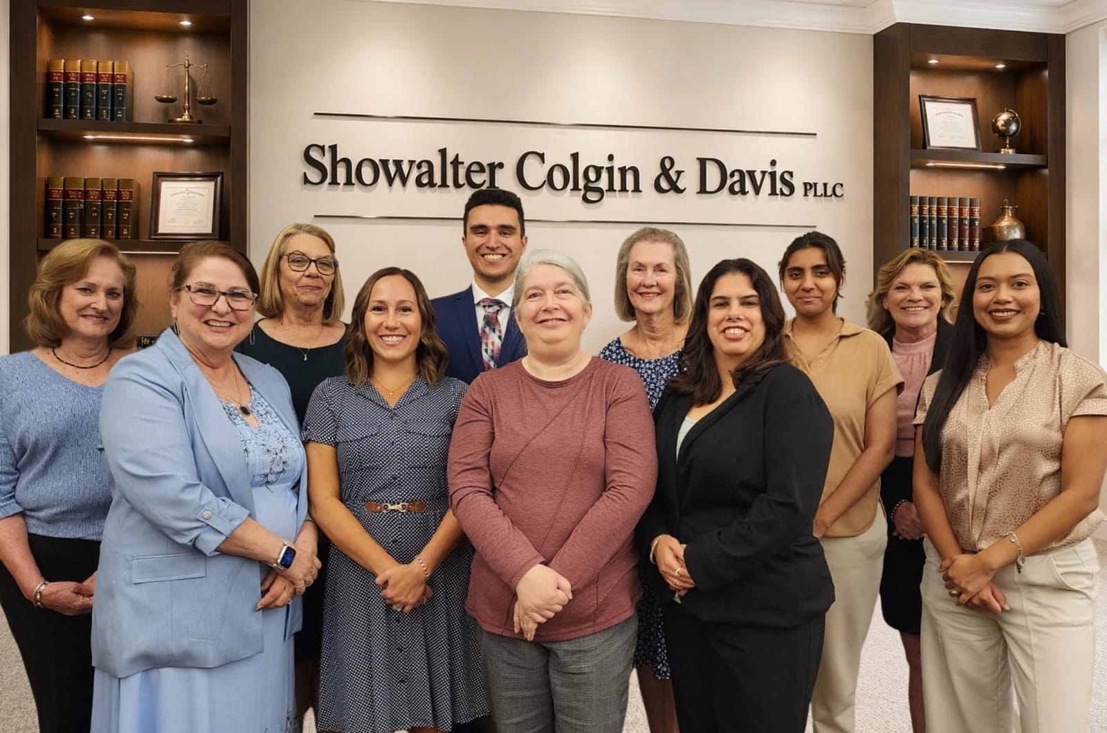 The legal support team of Showalter Colgin & Davis, PLLC gathered in front of the firm sign at the Richmond office